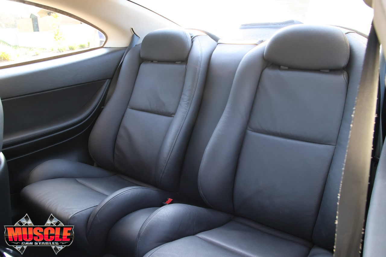 2002 Holden Monaro CV8 Devil Yellow - rear - rear seats